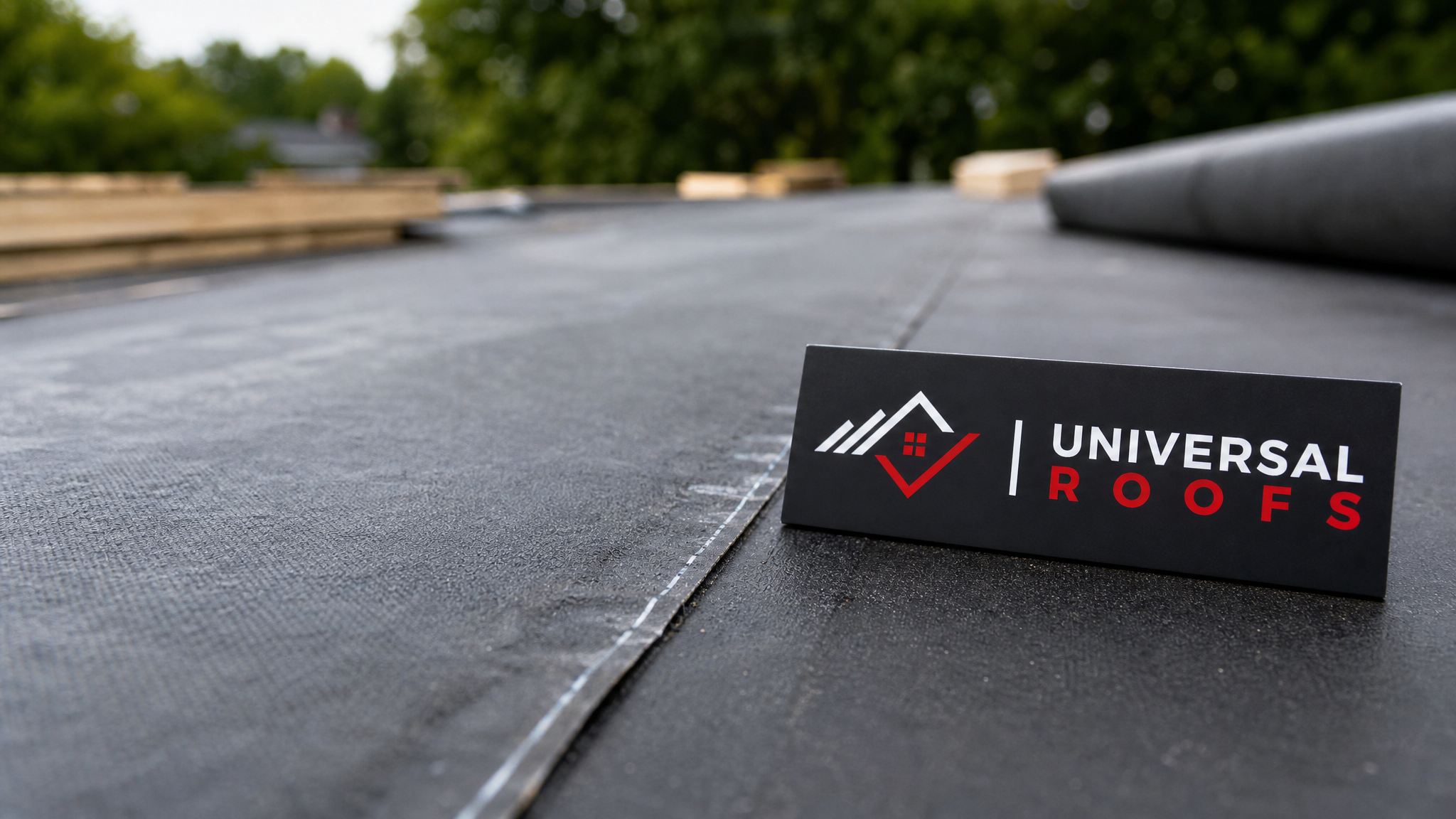 Close-up of textured synthetic roof underlayment overlapping at a fastened seam