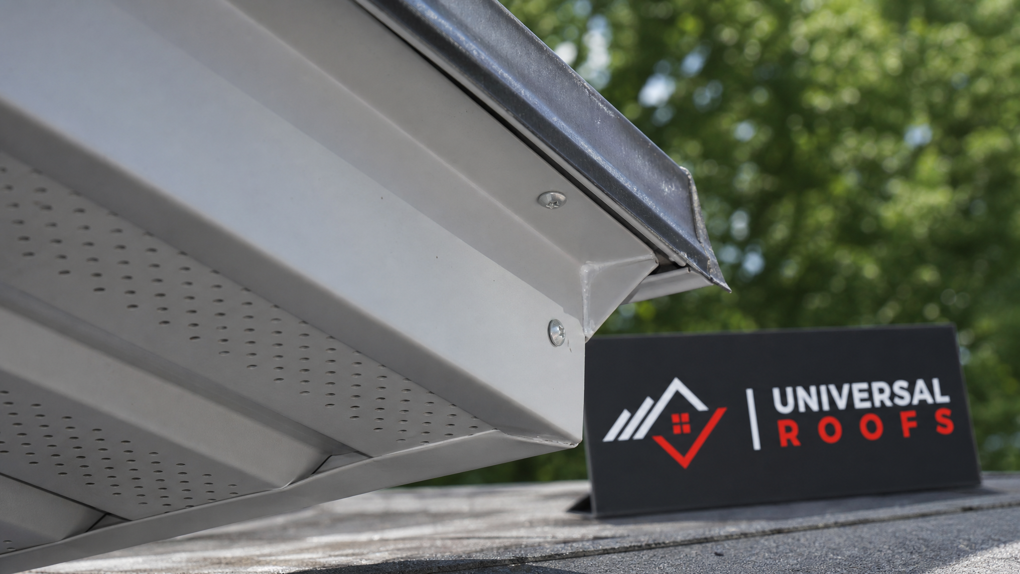 Close-up detail of vented aluminum soffit panel interlocking with new fascia trim and drip edge flashing