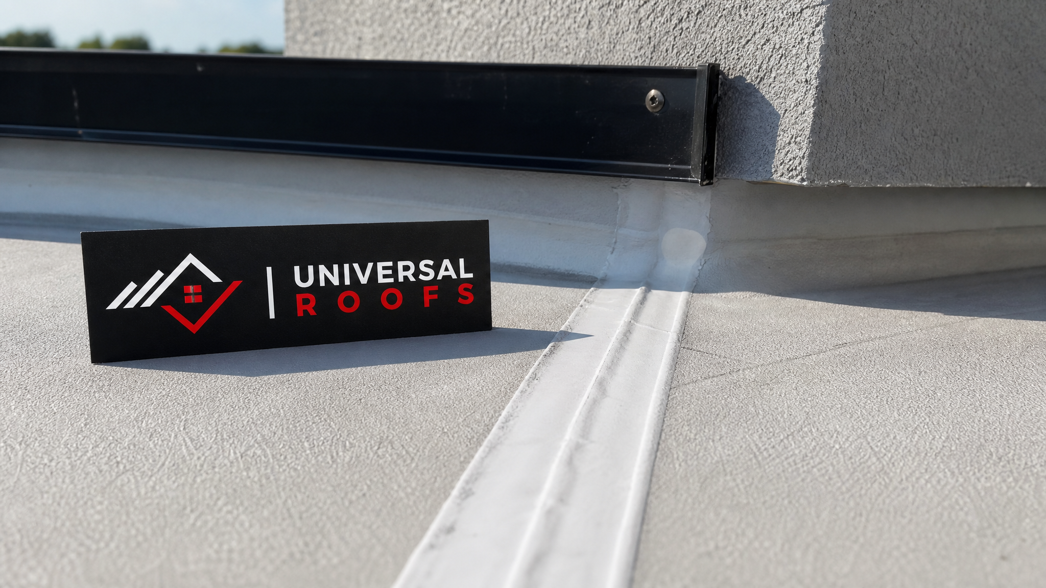 Close-up detail of a heat-welded TPO membrane seam and parapet flashing on a commercial roof with a branded Universal Roofs sign placard