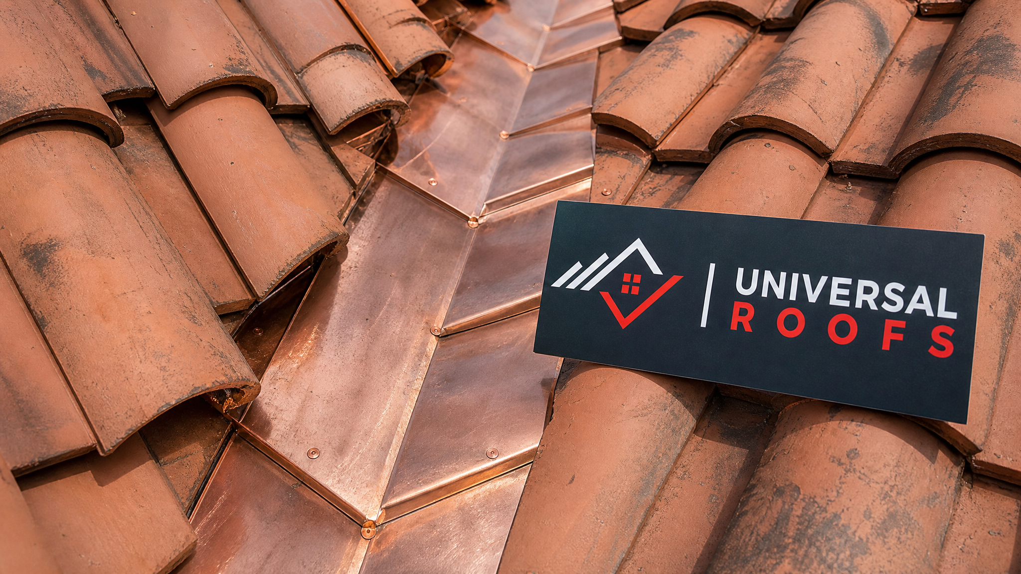 Close-up detail of new copper step flashing woven between tile courses on a roof valley