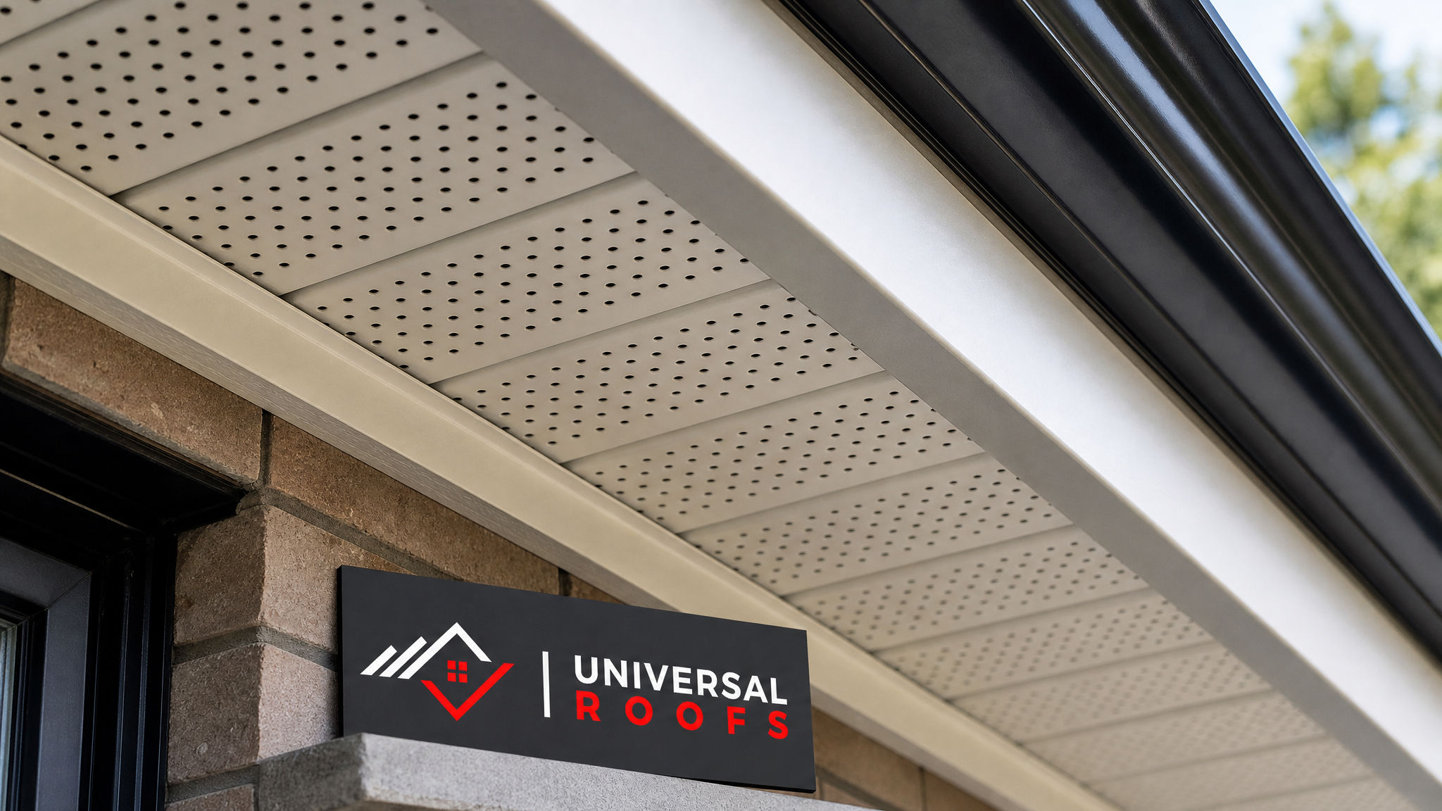 Close-up detail of vented aluminum soffit panel installed beneath a fascia board and eavestrough on a Toronto roofline