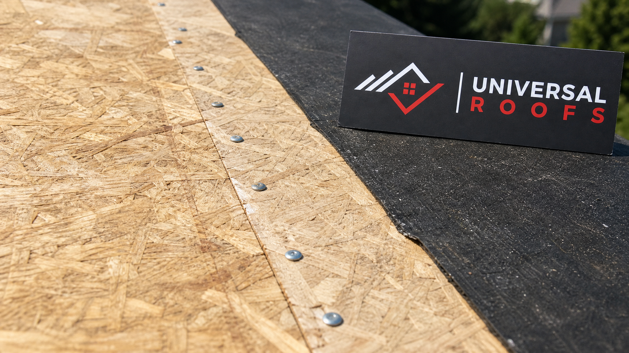 Close-up detail of new plywood roof decking panel with ring-shank nail fasteners and sealed seam