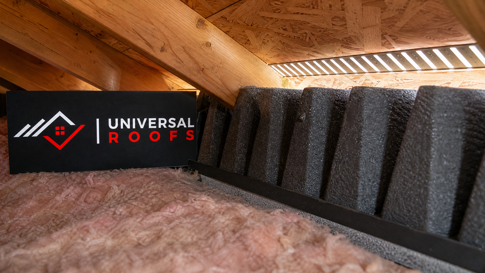Close-up of a soffit intake vent and foam baffle installed correctly to maintain attic airflow