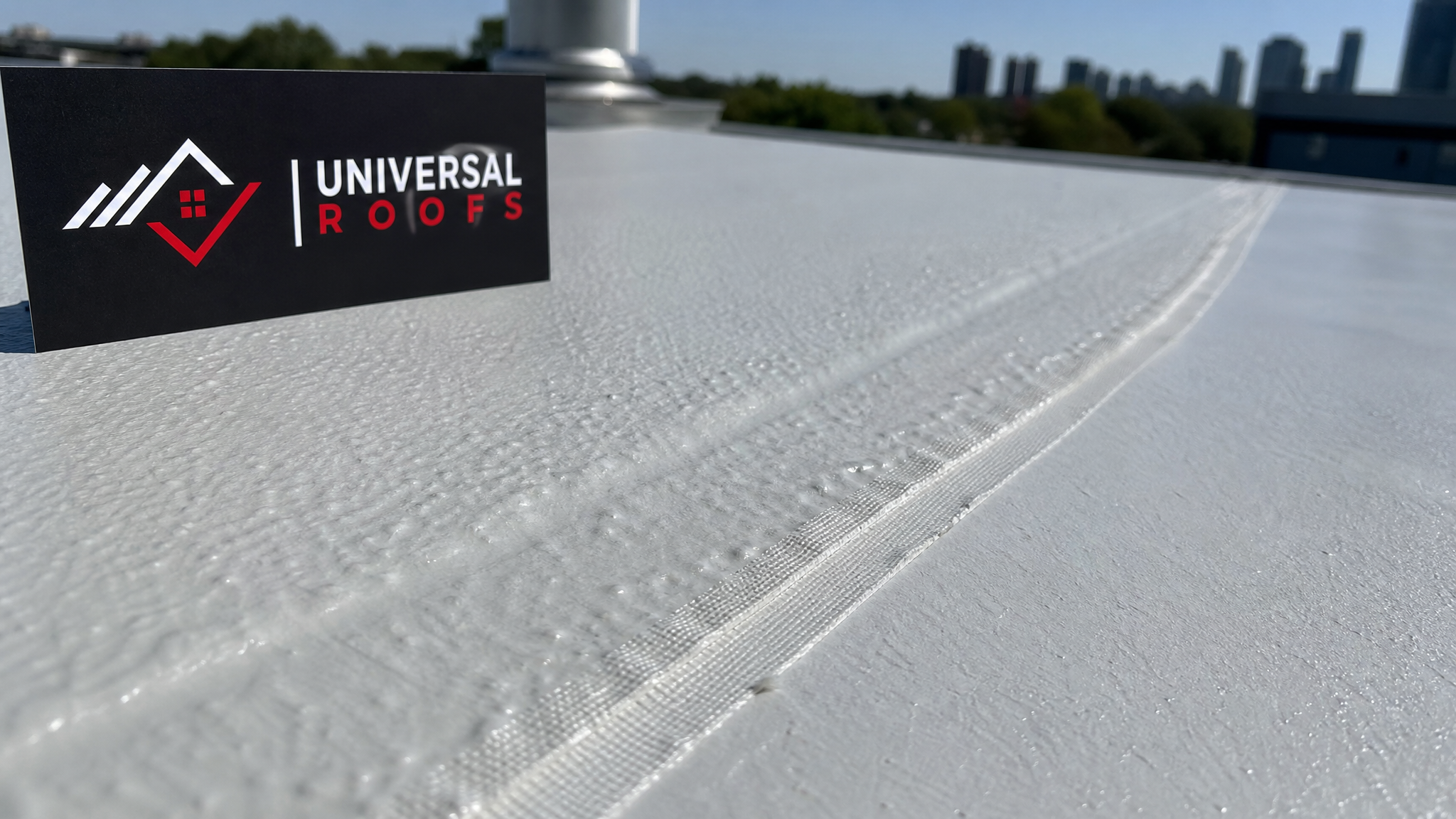 Close-up of reflective UV resistant roof coating texture with visible seam reinforcement fabric on a Toronto roof