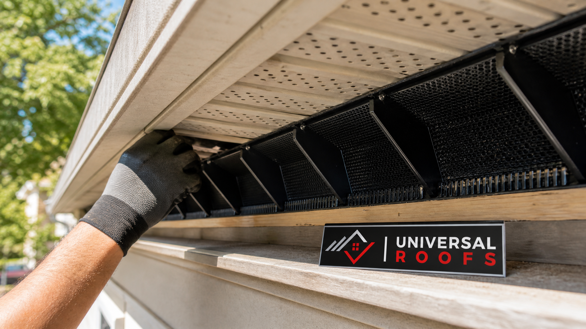 Close-up of a soffit vent and attic baffle installation showing proper intake airflow channel