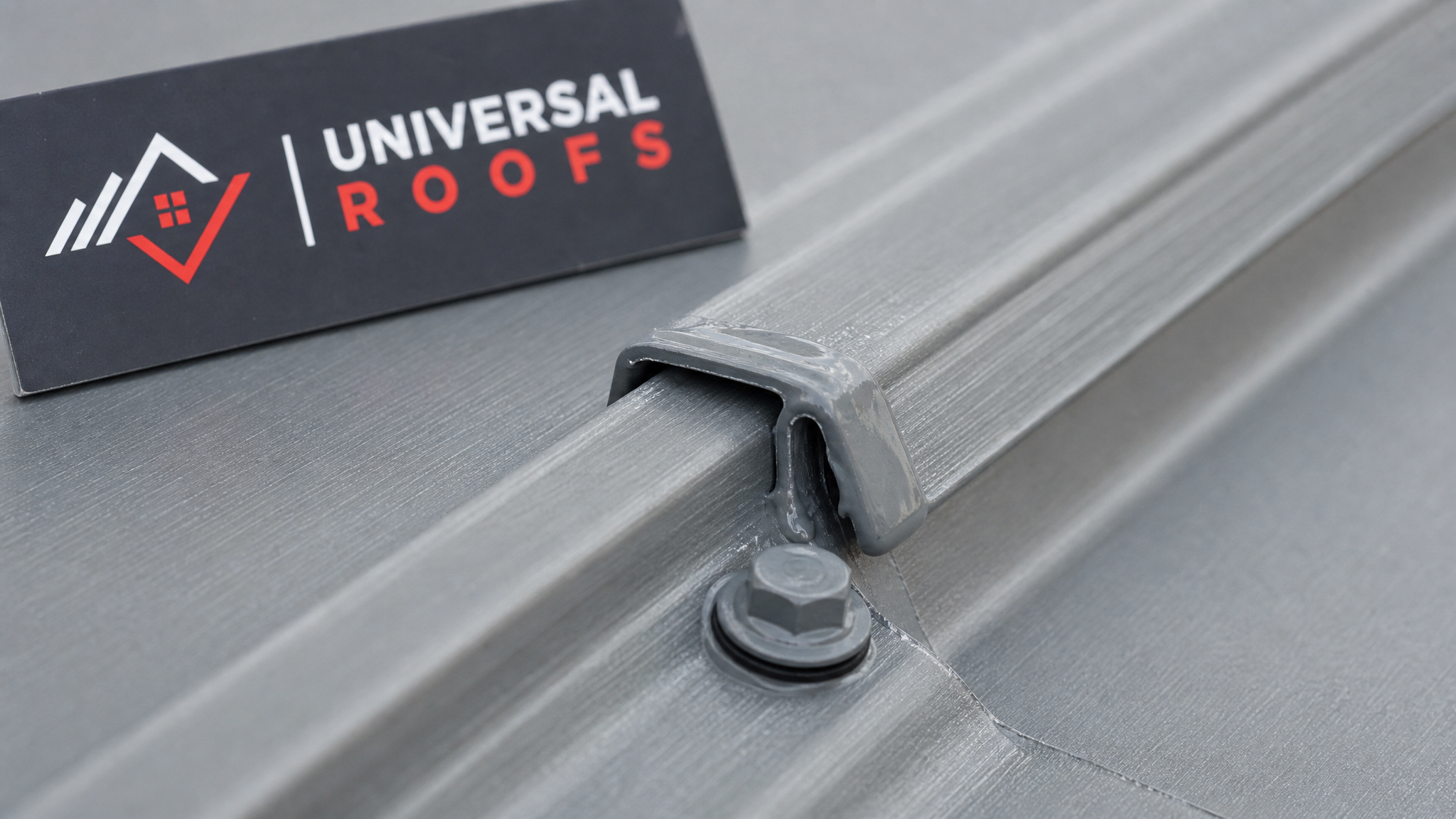 Close-up of a repaired metal roof seam with fresh sealant and matching fastener on a Toronto roof