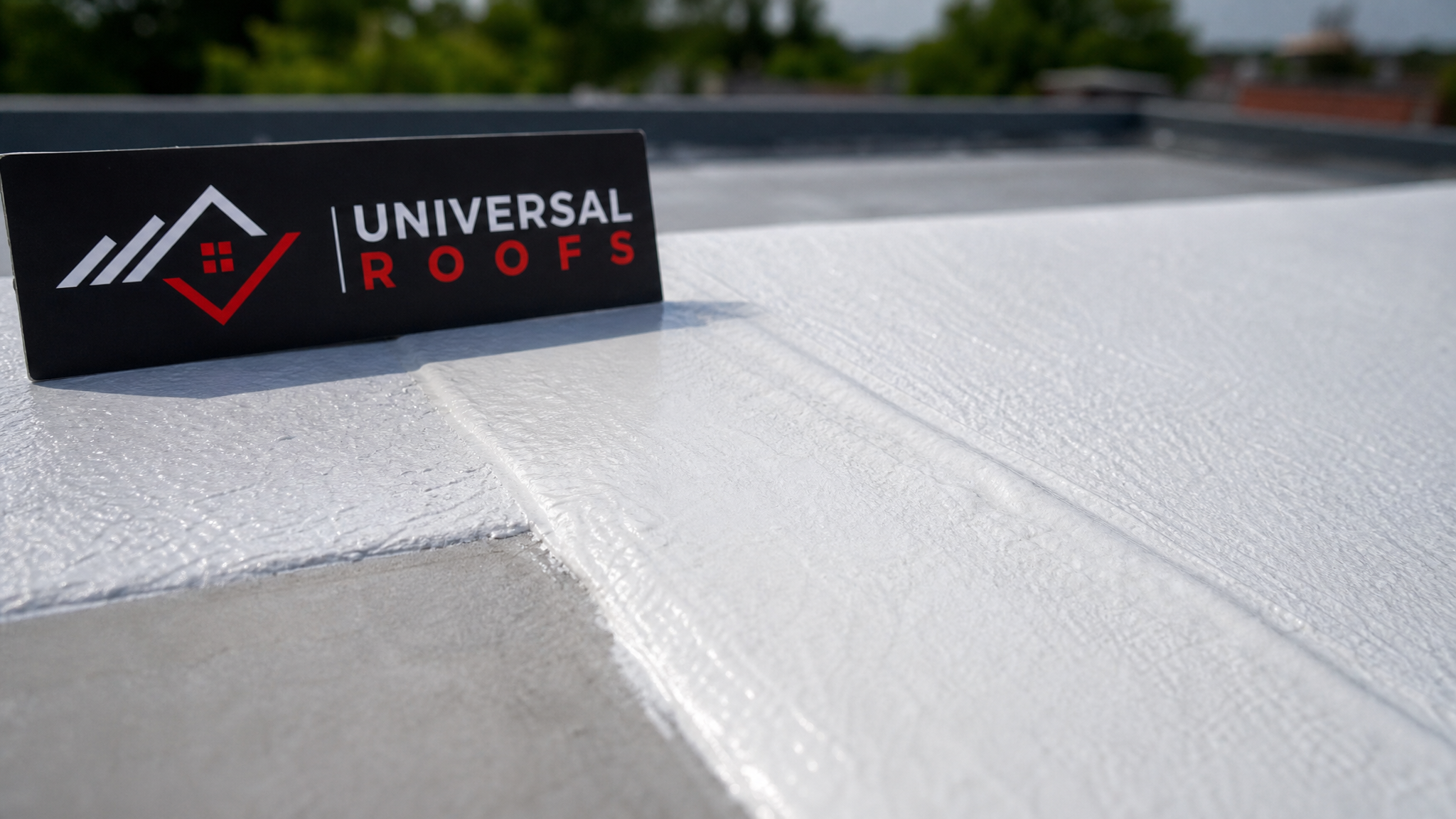 Close-up detail of cured silicone roof coating texture and seam application on a commercial roof membrane