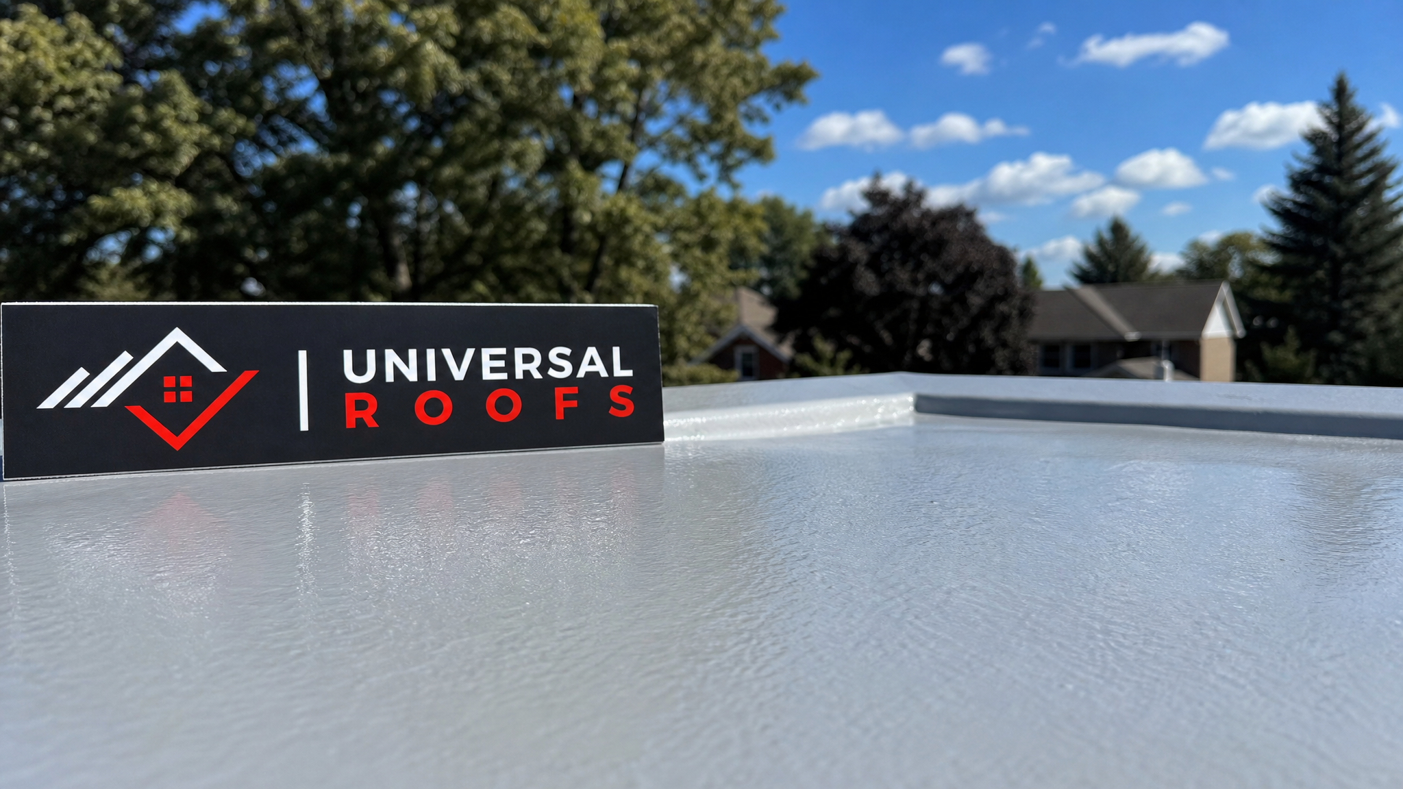 Close-up of cured silicone UV-protective roof coating showing seamless reflective membrane texture