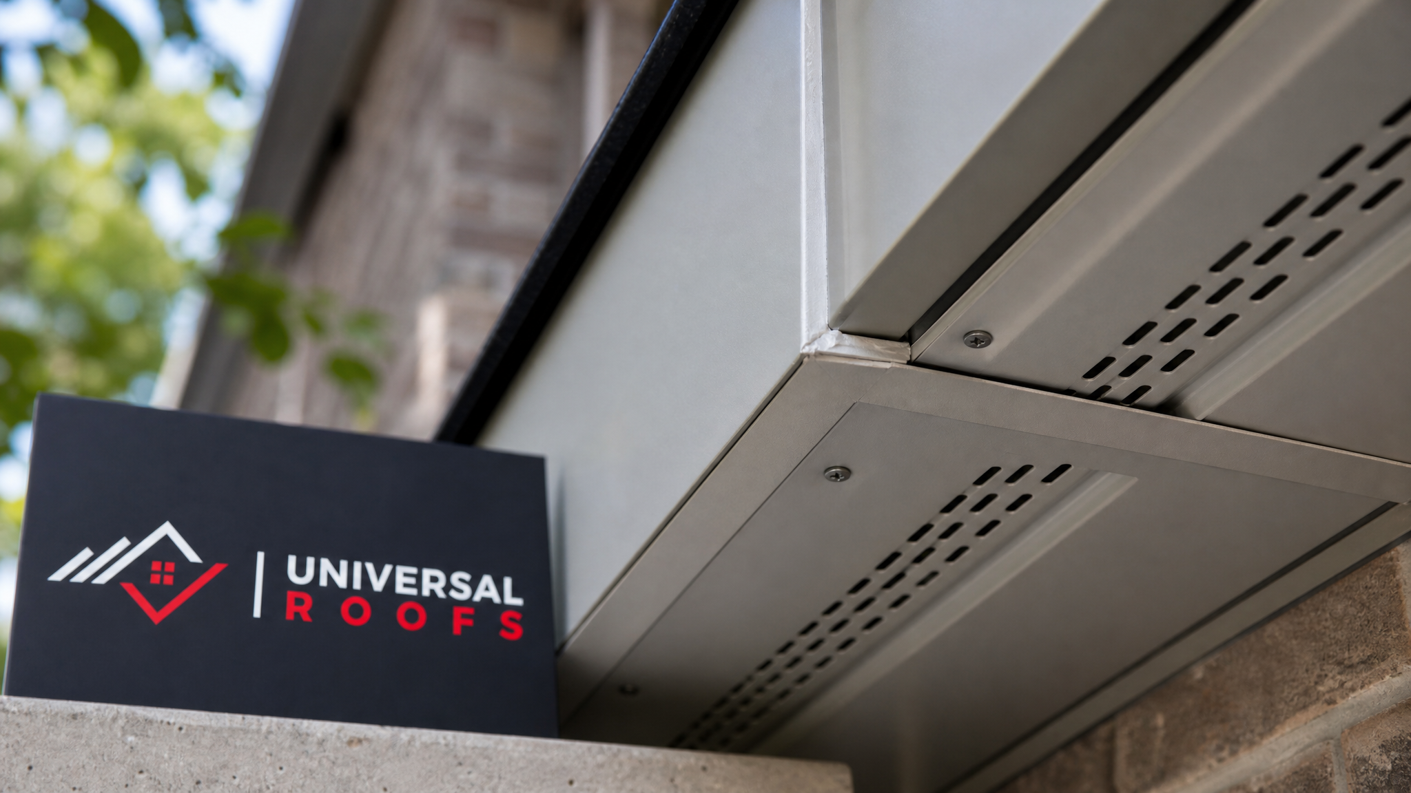 Close-up detail of a properly sealed vented aluminum soffit panel and fascia joint on a Toronto home