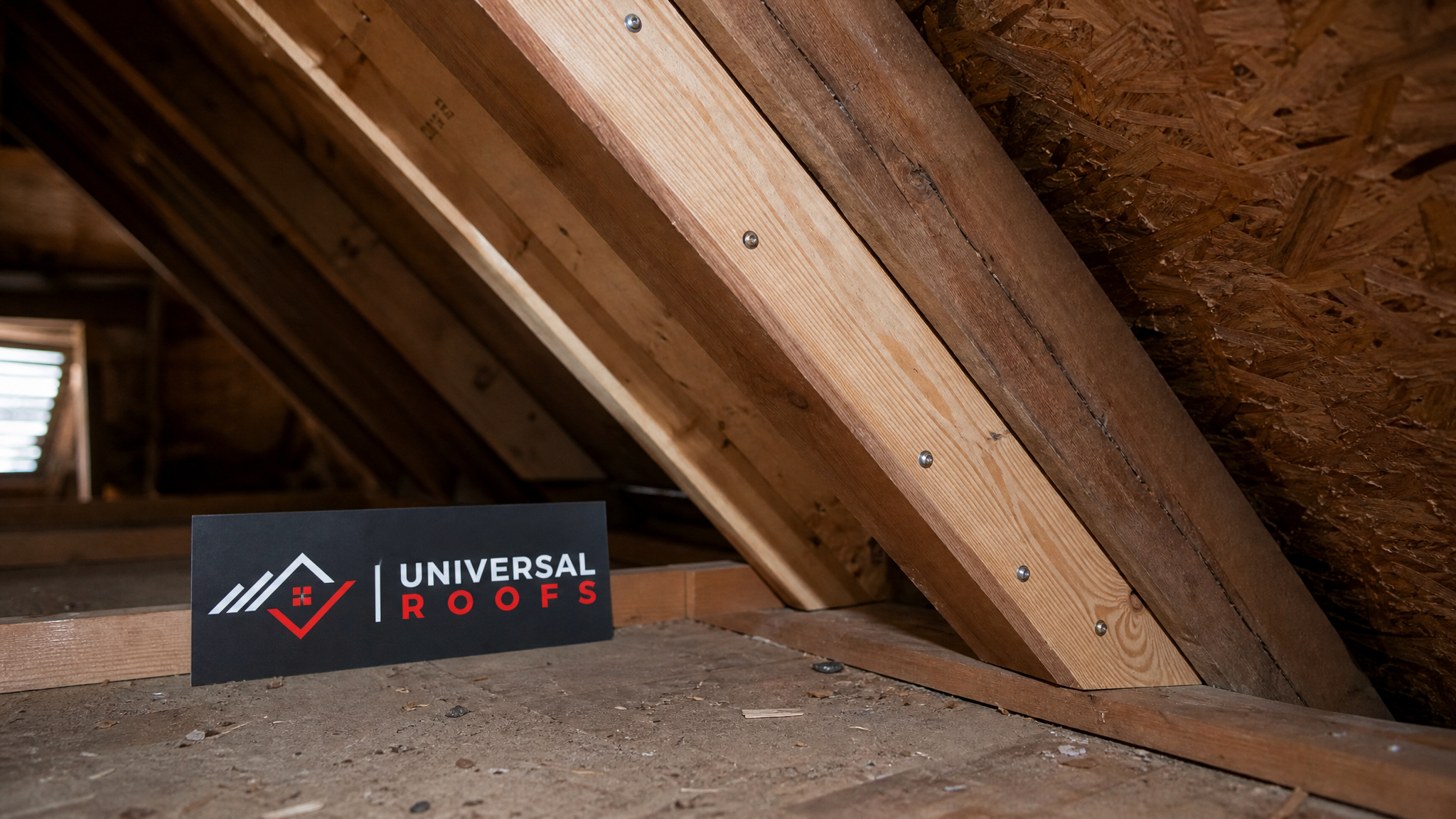 Close-up of new sistered rafter lumber fastened alongside an original roof rafter during structural sagging roof repair